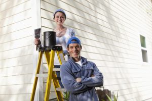 man and women painting the siding