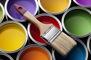 paint brush atop buckets of paint