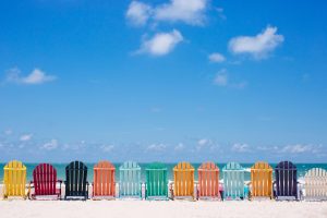 line of beach chairs on a summer day