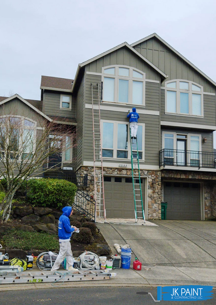 Photo of the JK Paint team painting an exterior of a large house Photo of the JK Paint team painting an exterior of a large house