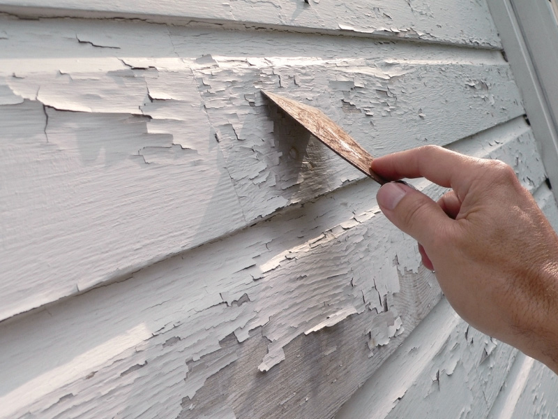 chipped-paint-being-scraped-off-of-old-wood-siding