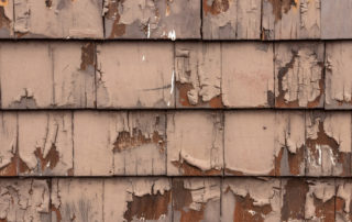 rotting-peeling-paint-falling-off-of-old-wooden-siding