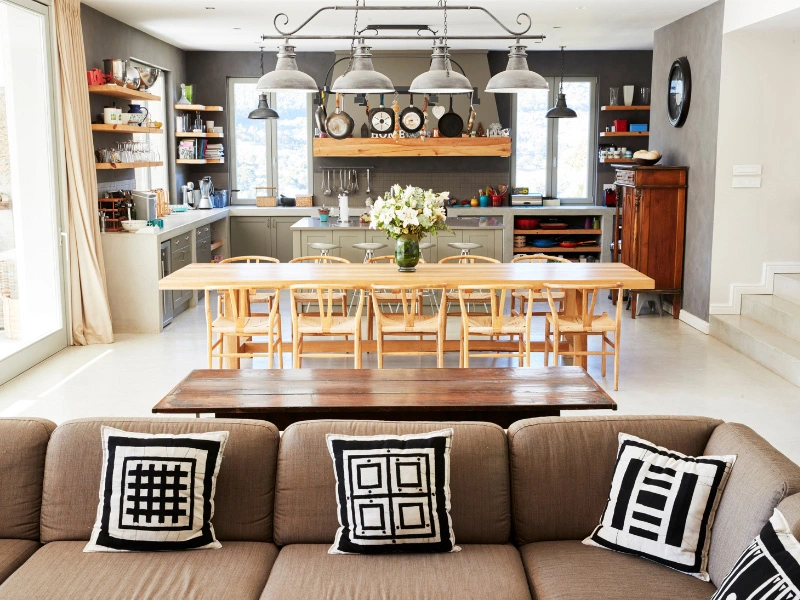 open-concept-space-with-kitchen-painted-gray-and-living-space-painted-a-shade-of-white