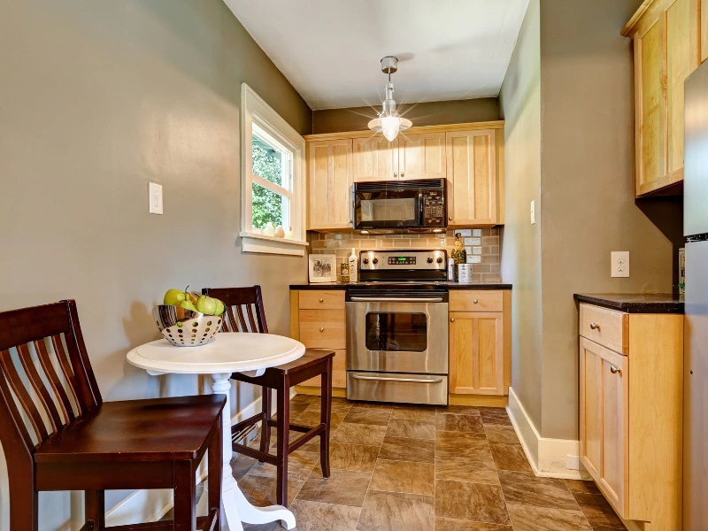 small-kitchen-and-dining-space-painted-gray-green-with-glossy-paint-finish