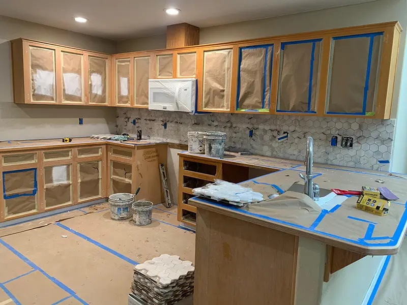 an-empty-kitchen-prepped-for-cabinets-to-be-painted