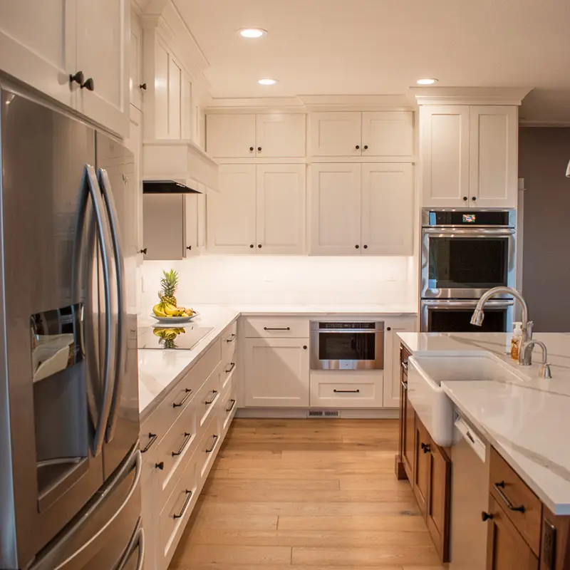 nice-kitchen-with-stainless-refrigerator-all-white-cabinets-and-wood-flooring