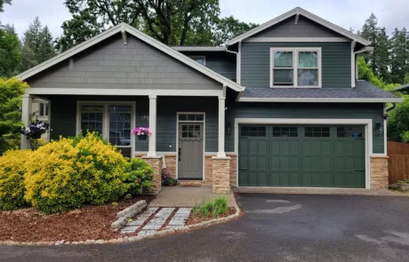 a two story green house in portland painted by jk paint & contracting
