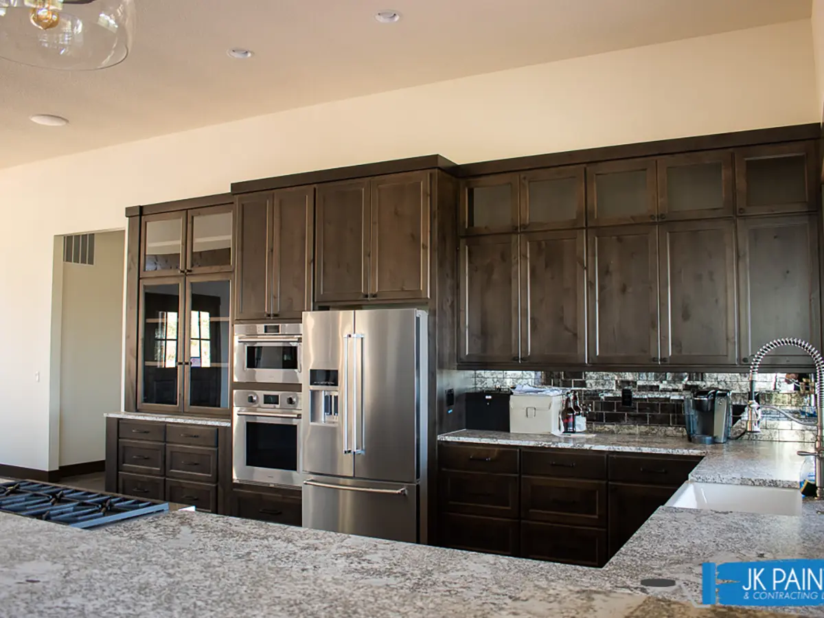 a kitchen with newly stained cabinets done by JK Paint & contracting in the portland area