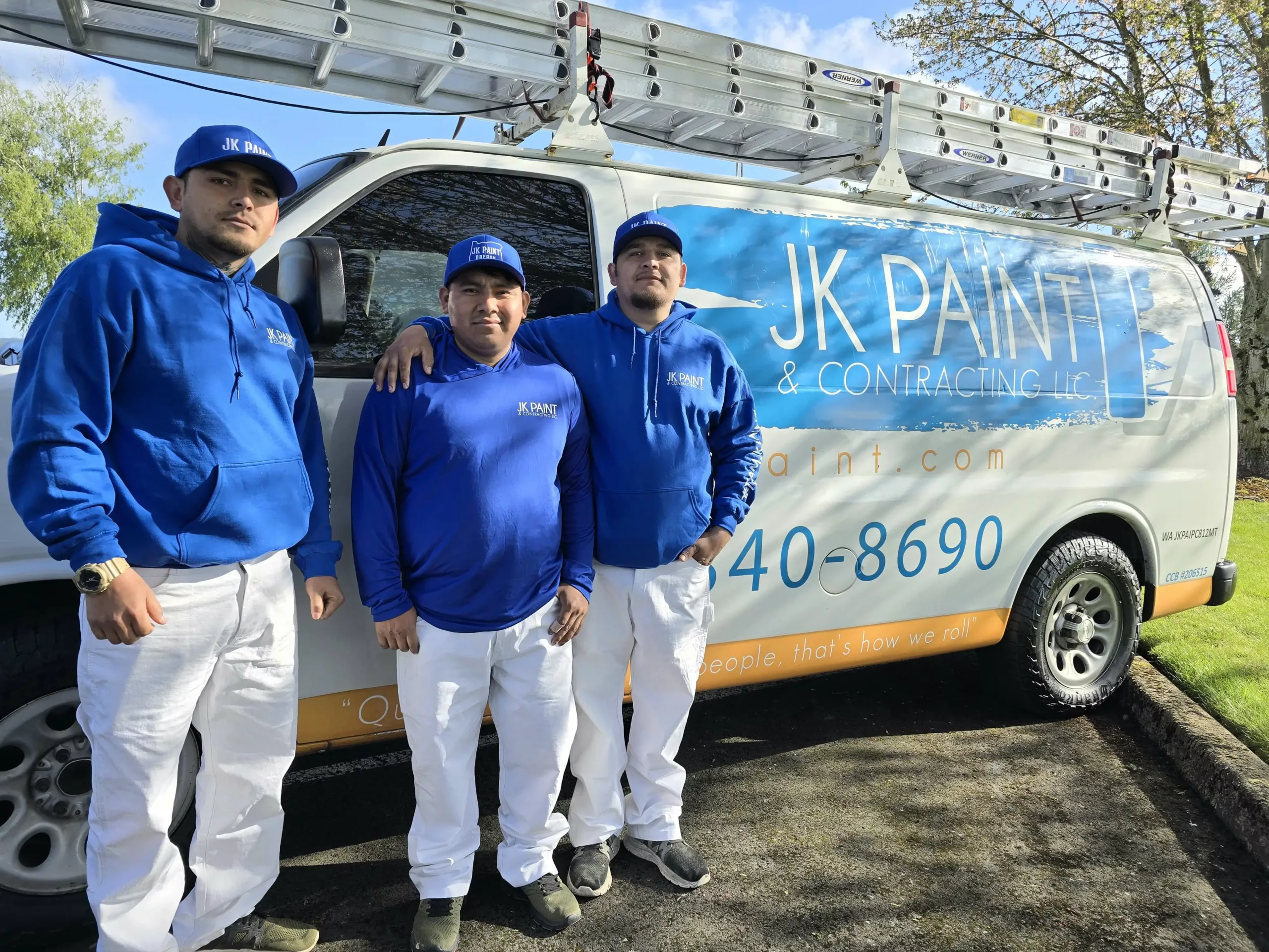 three guys on the jk paint crew standing in front of a van