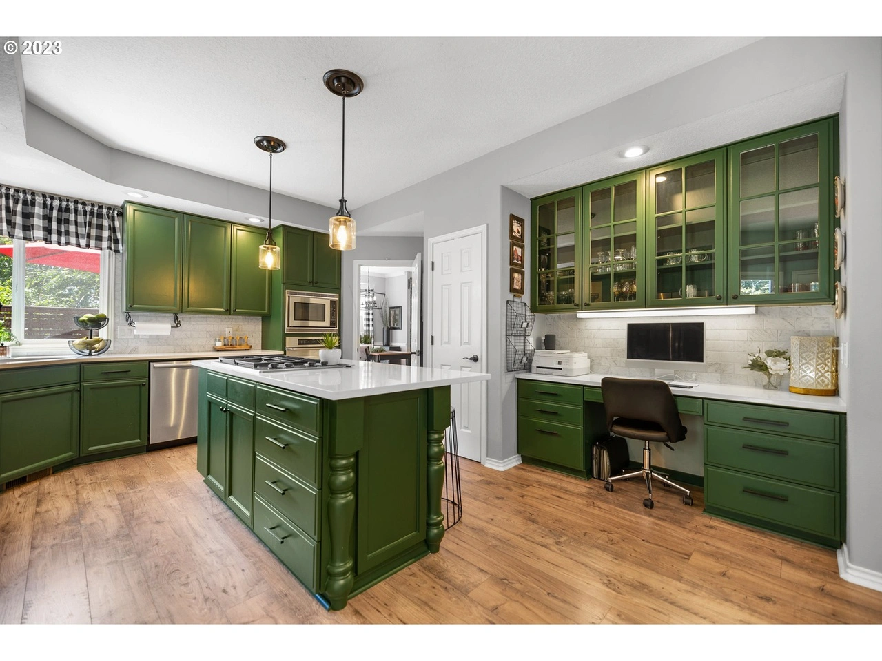 photo of a kitchen with freshly painted cabinets in green