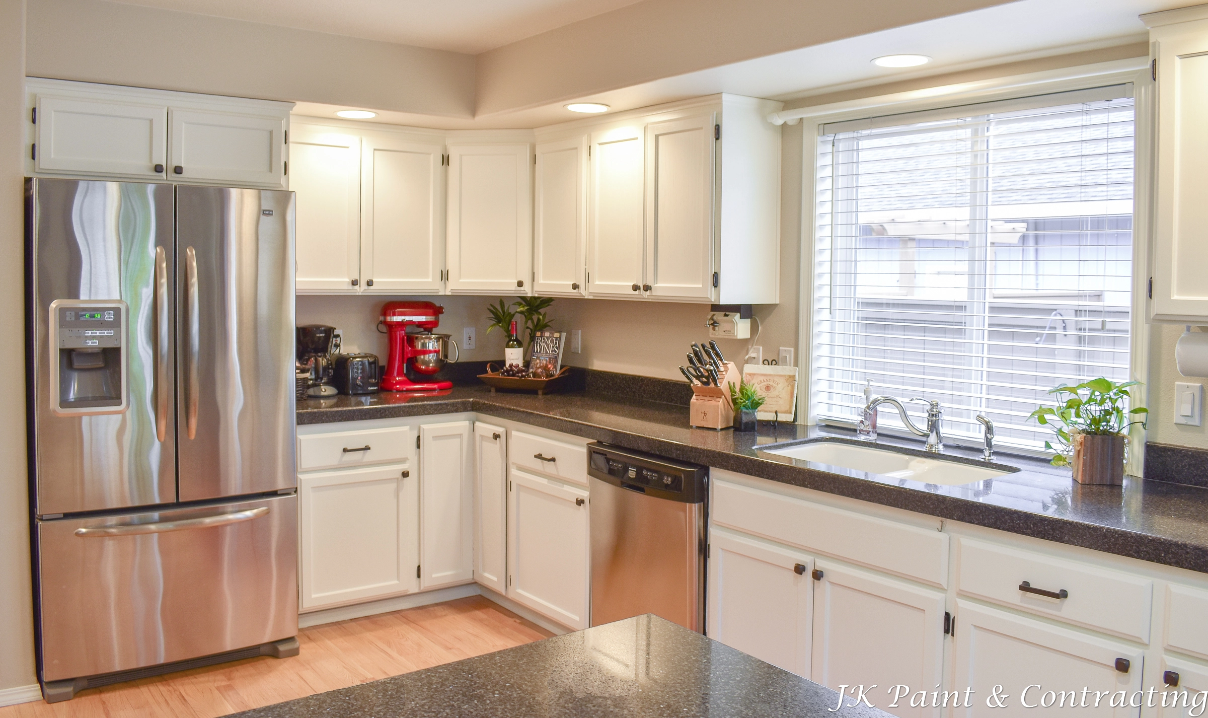 a photo of a kitchen in the portland area with nicely white painted cabinets