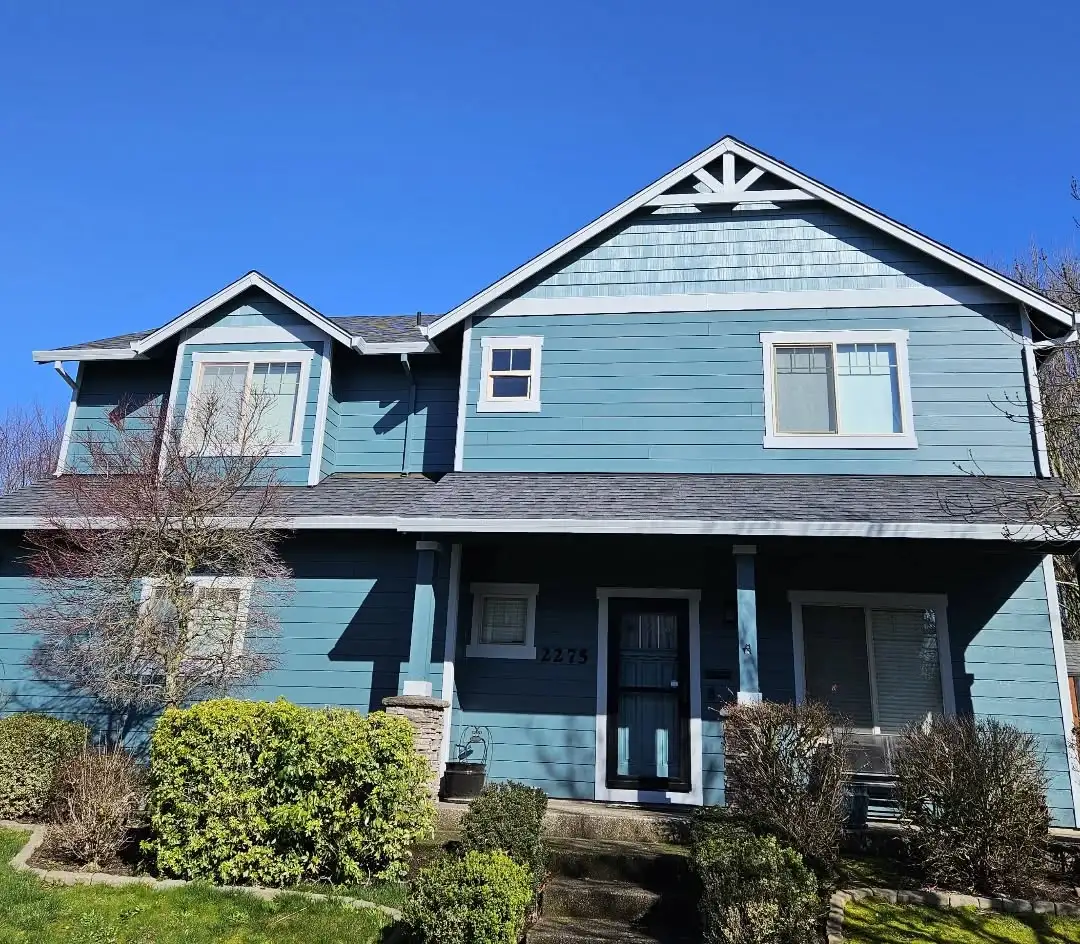 an after photo of a home in newberg after getting a paint job from JK Paint. house painted with a blue color pallette from Sherwin Williams paint